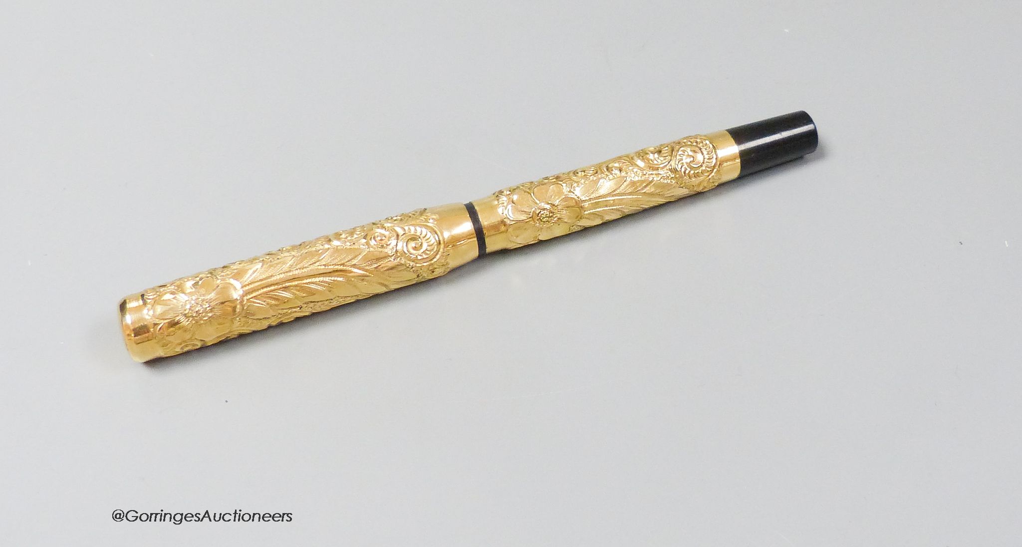 A 1920's gold plated eye-dropper fountain pen